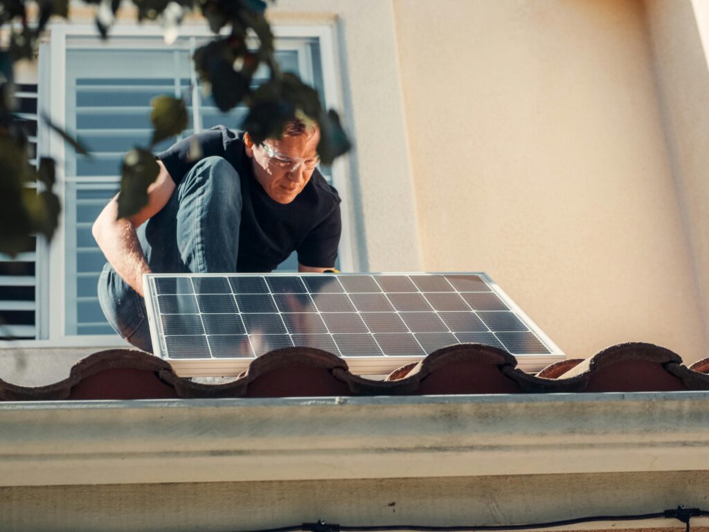a man setting up solar panel