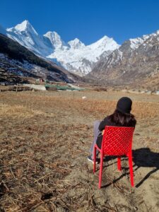 a girl sitting in the dantu village, looking over panchachauli peaks